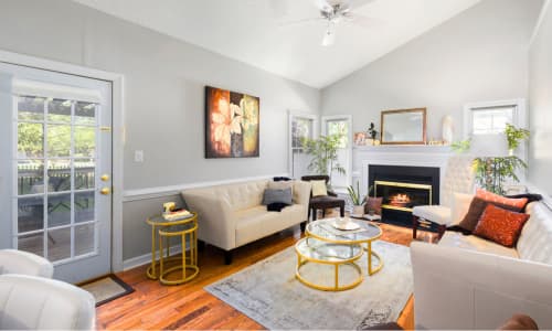 Bright modern living room interior with sofas, fireplace and natural light, representing high-quality property listings